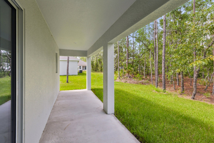 A walkway with grass and trees.