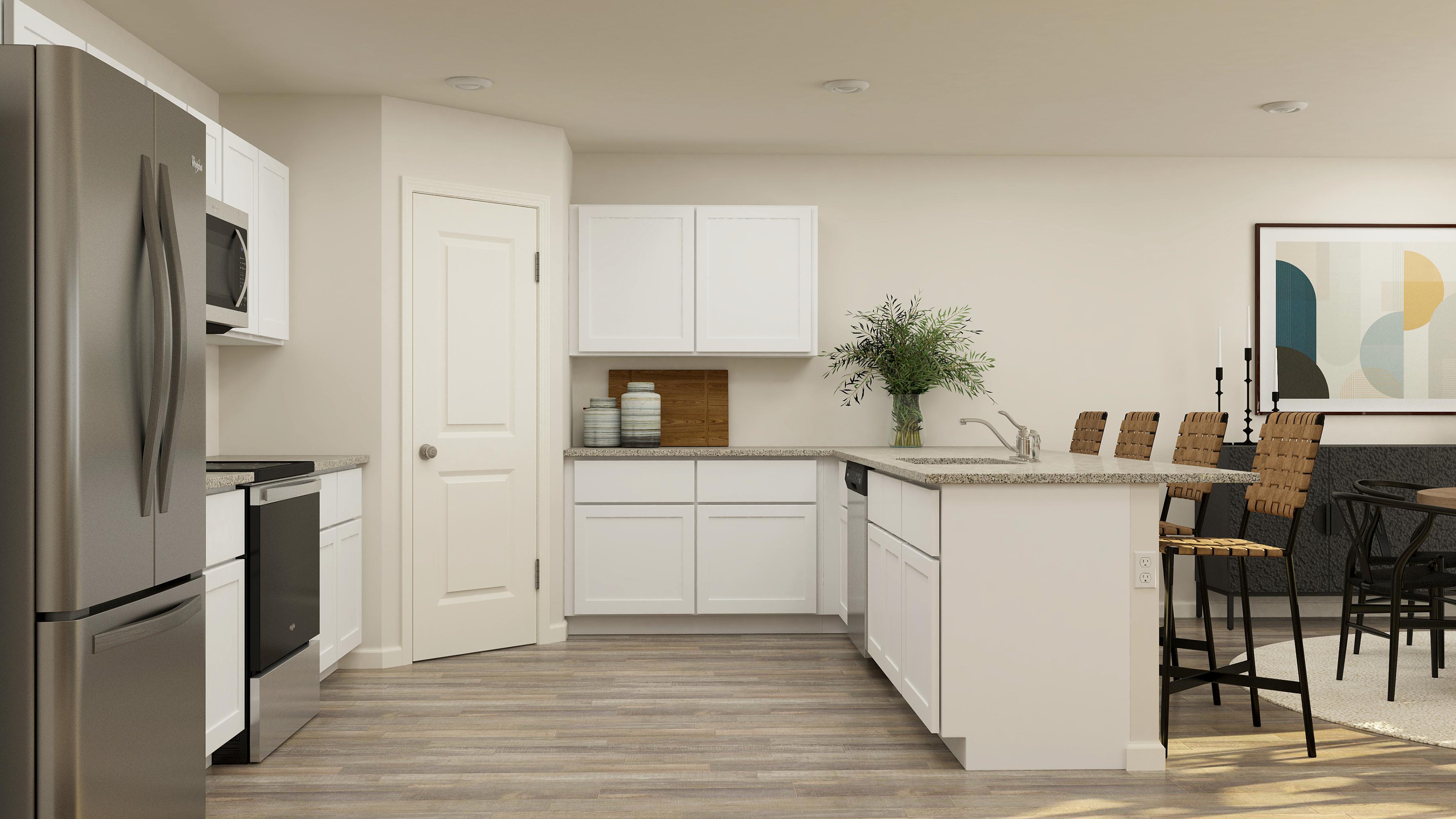 A kitchen with white cabinets.