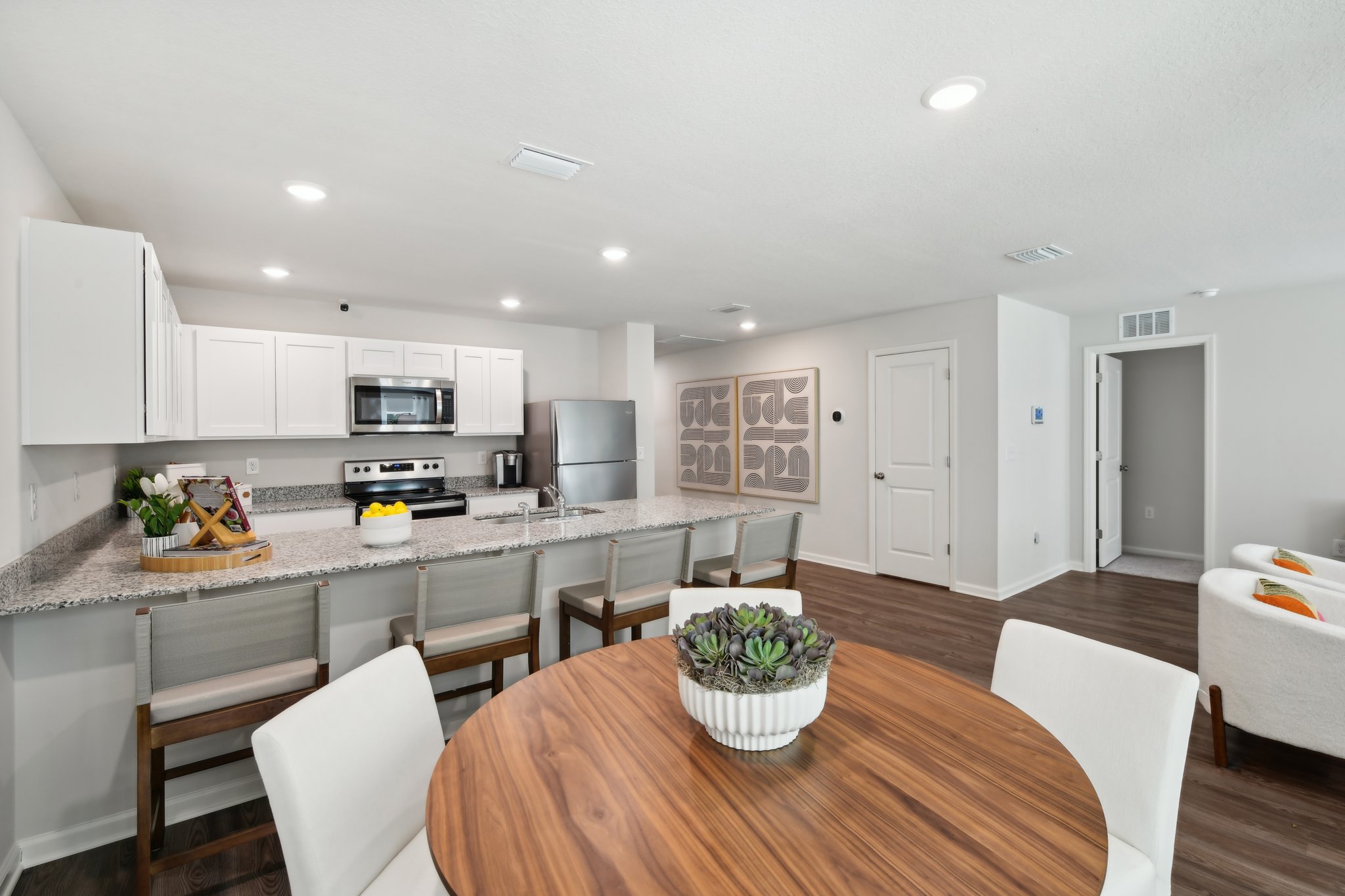 A kitchen with a dining table.