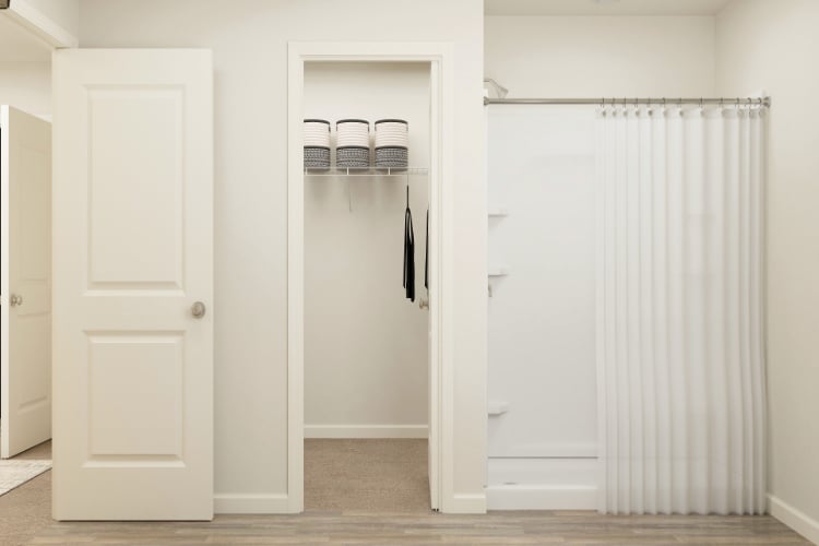A closet with white doors.