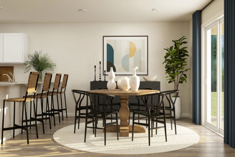 A dining room with a table and chairs.