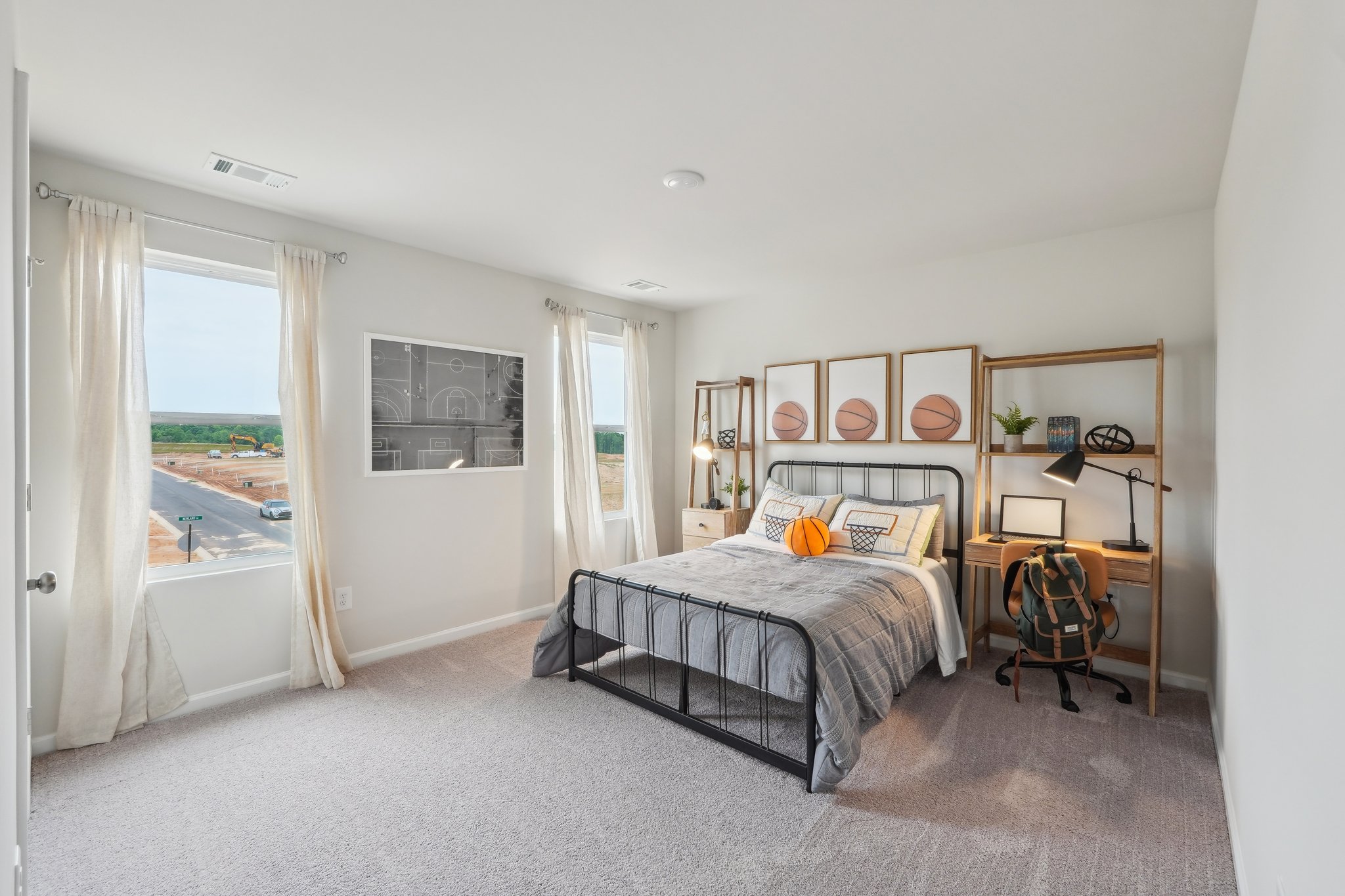 A bedroom with a bed and a chair.