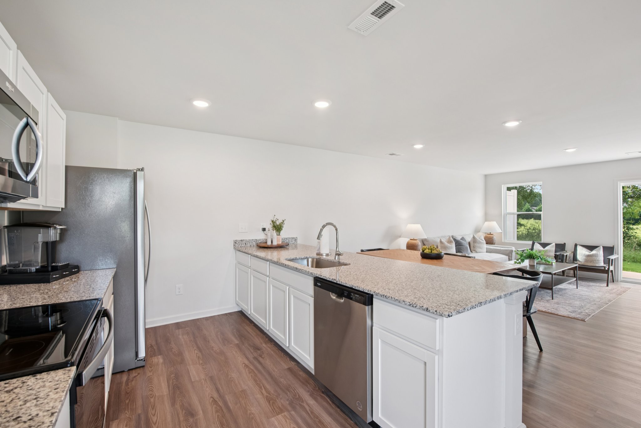 A kitchen with a wood floor.