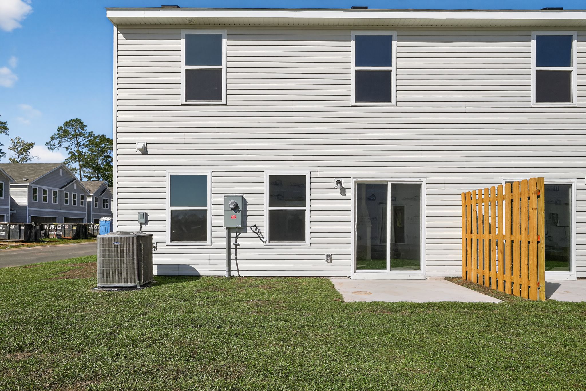 A white building with a yellow gate.