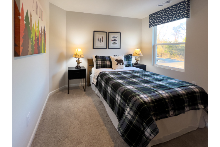 A bedroom with a bed and lamps.